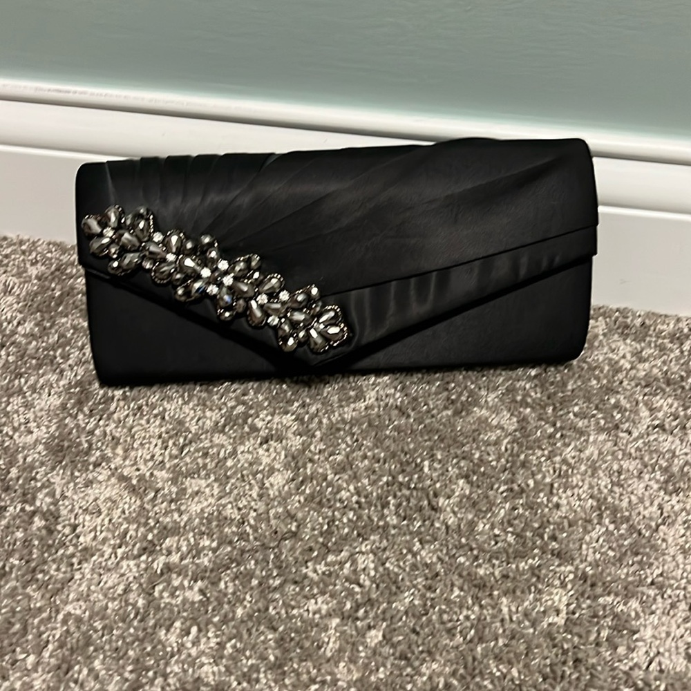 Brand new black clutch with accent.